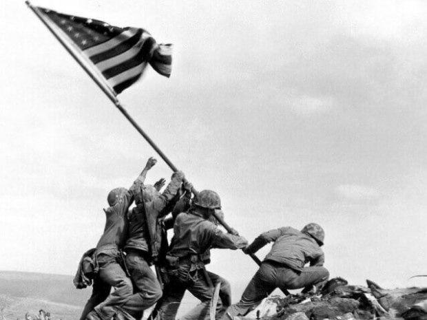 American soldiers raising the American flag during WW2.